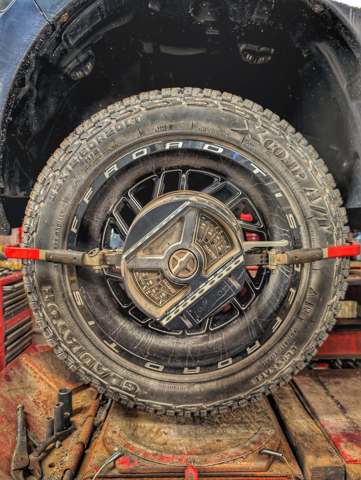 Alignment clamp on wheel during service