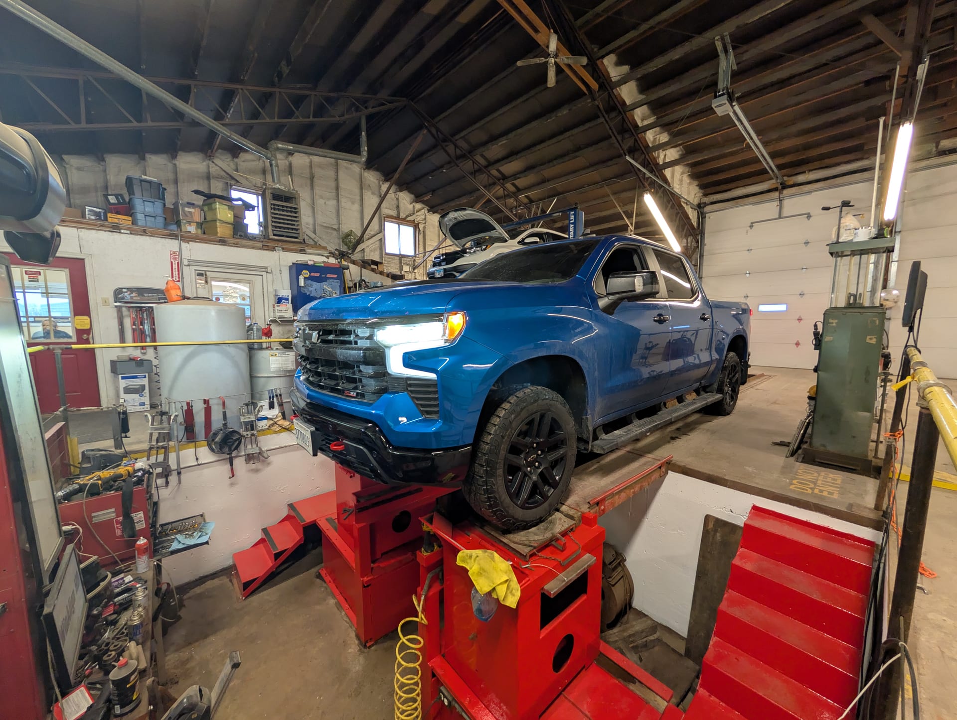Blue Chevy truck on the alignment rack